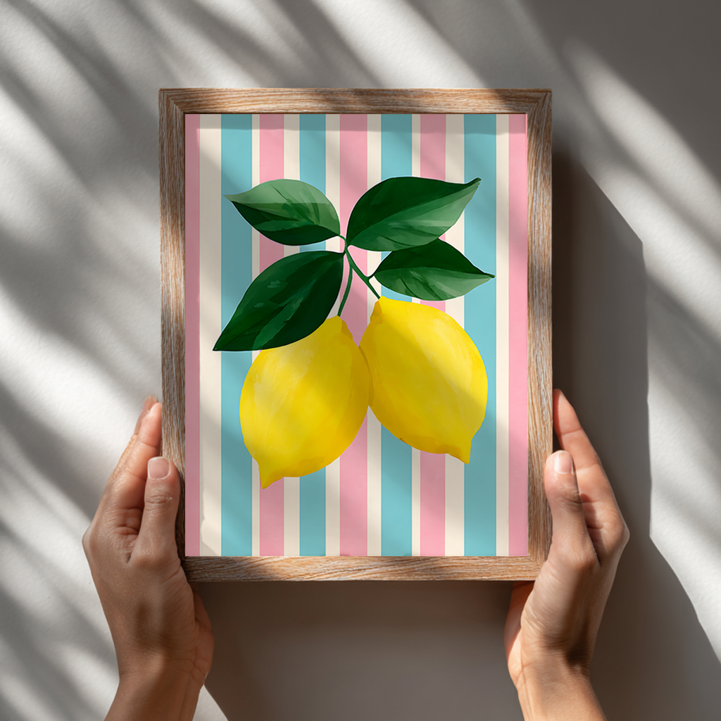 Hands holding a framed lemon art print with colourful striped background, minimal fruit poster display