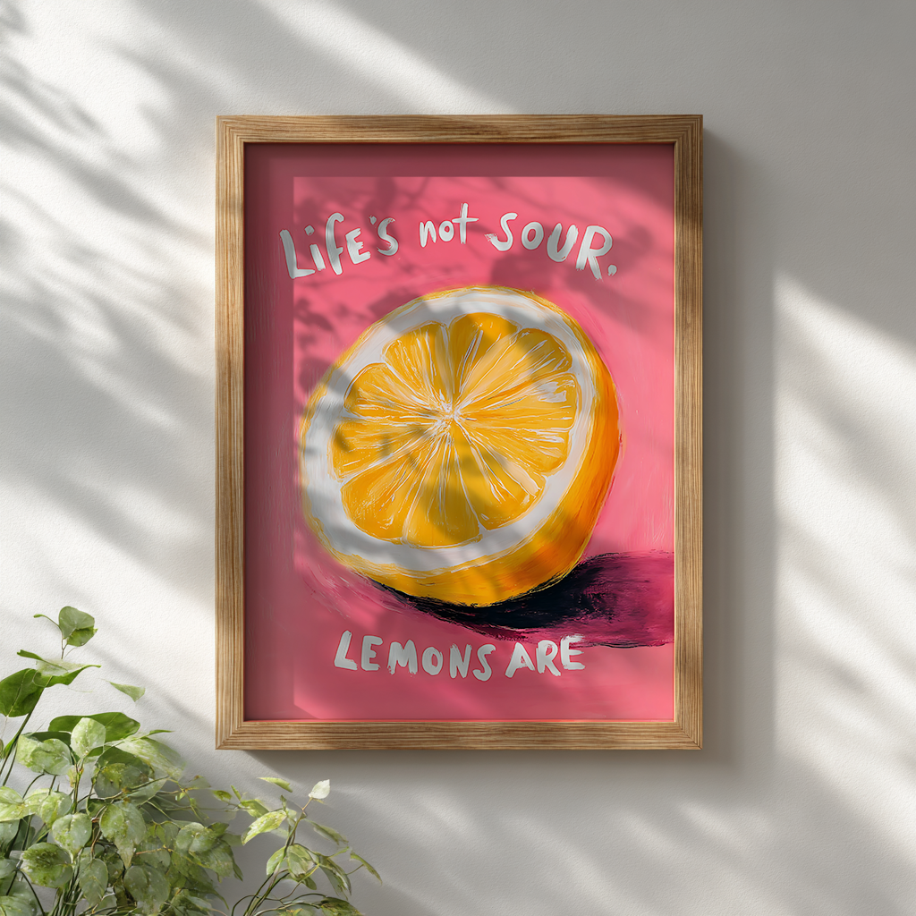 Quirky motivational lemon poster with vibrant yellow citrus and pink background displayed in wooden frame on white wall for modern wall decor

